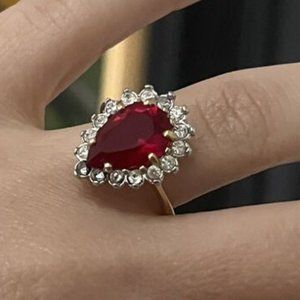 18K HGE SYNTHETIC PEAR SHAPED RUBY RING ADORNED BY RHINESTONES